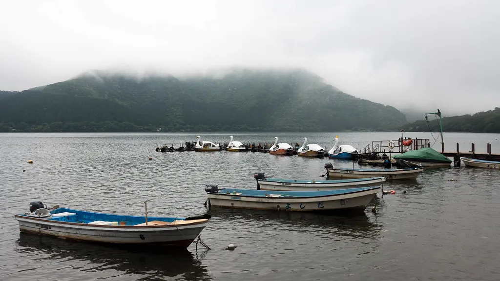 Rowing boats moored on Lake Ashi in Hakone under low cloud